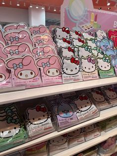 many hello kitty stickers are on display in a store shelf with other items behind them