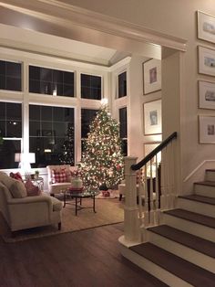 a living room filled with furniture and a christmas tree