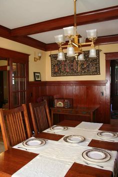 the dining room table is set with place settings for four people to sit and eat