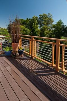 a wooden deck with potted plants on it