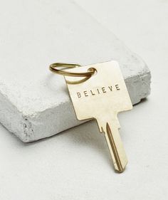 Gold or silver jump ring Hand-stamped key measuring 2 2/5" long x 1 1/3" wide Customize your word for $8 more by typing into the field above Giving Keys, 15 Year Anniversary, What Makes You Unique, Ring Keychain, Birthday Congratulations, Gold Key, Key Jewelry, School Collection, Your Word