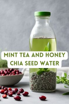 a glass bottle filled with green tea and honey chia seed water next to cranberries