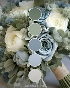 a bridal bouquet with white roses and greenery on the bottom, blue hues