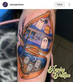 an image of a halloween themed tattoo on someone's left arm with ghost in the mirror