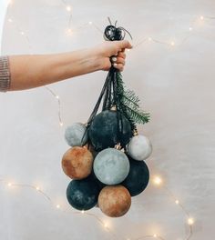 a person holding a bunch of ornaments in their hand