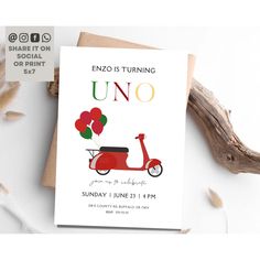 an uno birthday card with a red scooter and balloons on it, sitting next to some dried flowers