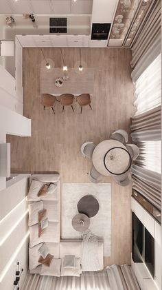 an overhead view of a living room and dining area in a modern apartment with wood flooring