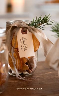 a jar filled with cookies sitting on top of a wooden table