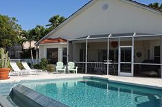 a house with a swimming pool and patio furniture