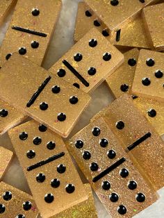 gold glitter dominos with black dots on them