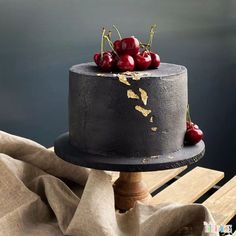 there is a cake with cherries on top