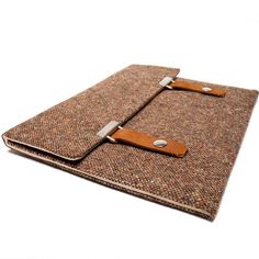 an ipad case with a leather handle on the front and back cover is made out of brown tweed