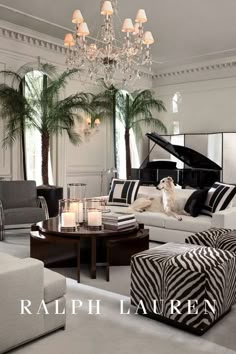 a living room filled with lots of furniture and a grand piano in the middle of it