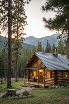 a log cabin with a metal roof in the woods at sunset or dawn, surrounded by pine trees and mountains