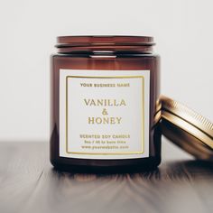 a jar of vanilla and honey candle sitting on a table