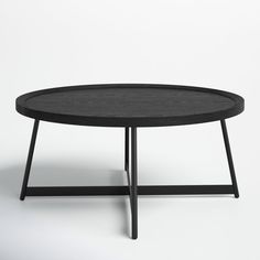 a black table sitting on top of a white floor next to a wooden frame and metal legs