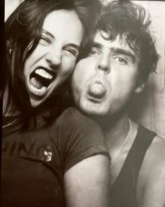 two people are posing for the camera with their mouths open