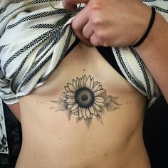 a woman with a sunflower tattoo on her stomach