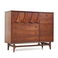 an old wooden dresser with many drawers and pulls on the front, against a white background