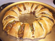 a large meatball roll sitting on top of a pan