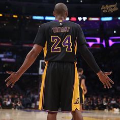 a basketball player standing on the court with his hands out