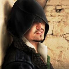 a man with a hood on leaning against a wall