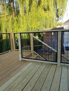 a wooden deck with metal railing and gate