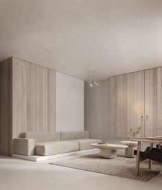 a living room filled with furniture next to a white table and wall covered in wooden paneling