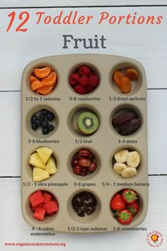 the 12 toddler portions are arranged in a divided tray with fruits and berries on it