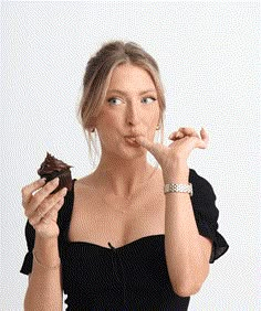 a woman holding a piece of food in her hand and making a funny face with her fingers