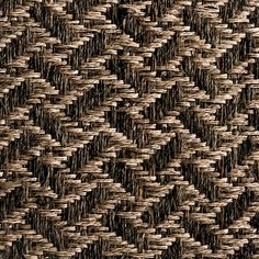 an up close view of a woven material with brown and black colors on the surface