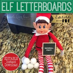 an elf is sitting on the counter next to some snowballs and a blackboard