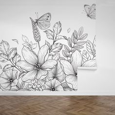 an artistic wall mural with flowers and butterflies on the wall, painted in black and white