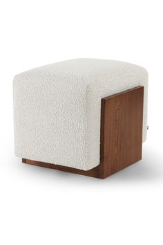 a white and brown ottoman with wood frame on the bottom, in front of a white background