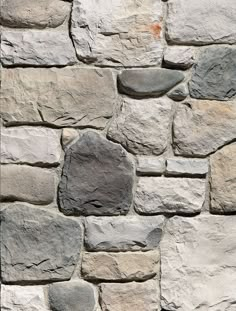 a stone wall made out of different types of rocks