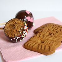 two cookies and an apple on a pink napkin