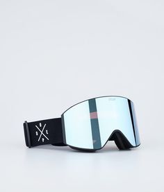 a pair of ski goggles sitting on top of a white surface