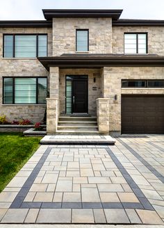 a large brick house with two garages on the front and one entrance to it