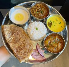 a silver plate topped with different types of food