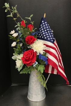 a vase with flowers and an american flag