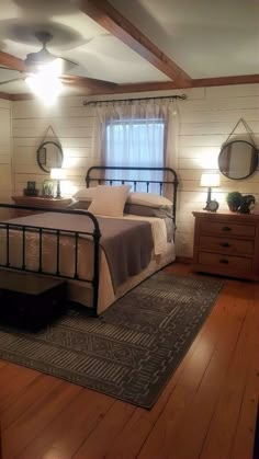 a bed room with a neatly made bed and wooden floors