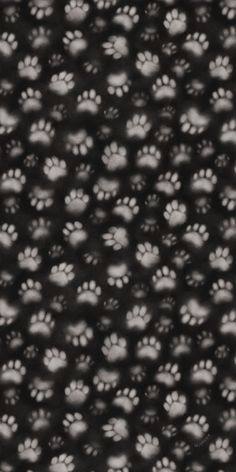 a black and white photo with paw prints on it's back ground, looking like an animal print