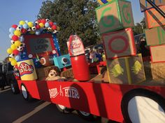 a parade float with toys and decorations on the back