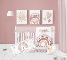 a baby's room with pink walls and pictures on the wall