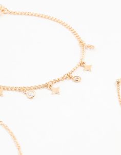 Channel your inner starlet with this set of three gold anklets, ideal for sleek and effortlessly cool styling. Featuring star droplets, gold balls, and a twisted chain design, mix and match for a contrasting look or wear solo for subtle elegance. Material: Crystal Dimensions: Length: 210 mm Extender: 50 cm | Lovisa Gold Diamante Star Drop Anklets 3-Pack, Clear Twisted Chain, Gold Anklet, Subtle Elegance, Chain Design, Mix N Match, Mix And Match, Anklets, Sleek, Crystals