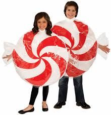 two people holding giant candy canes in their hands