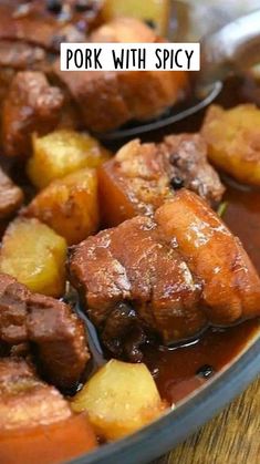 some meat and potatoes are in a bowl with sauce on the side, ready to be eaten