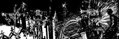 black and white photograph of chandeliers hanging from the ceiling in a dark room