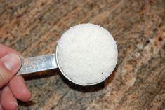 a person holding a spoon with sugar on it