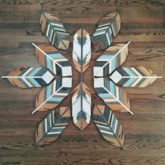 a wooden table topped with lots of different types of paper arrows on top of it